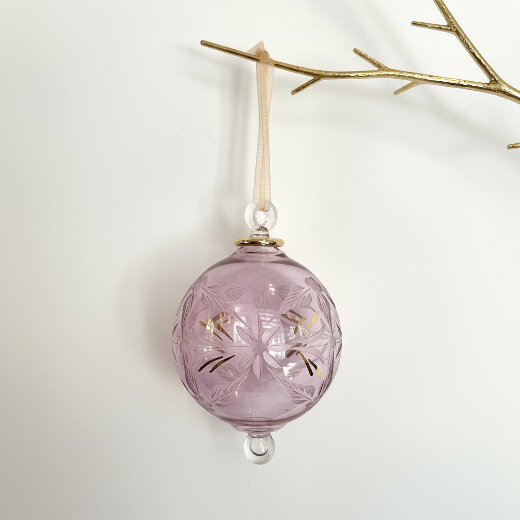 Blown glass bauble ornament with a pink tint and gold detail, featuring etched flowers