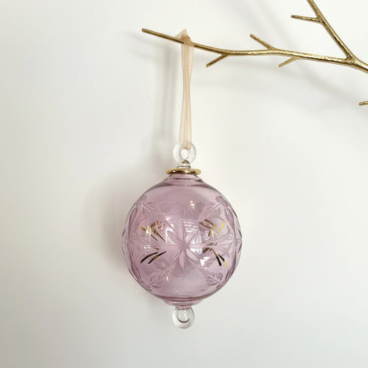 Blown glass bauble ornament with a pink tint and gold detail, featuring etched flowers
