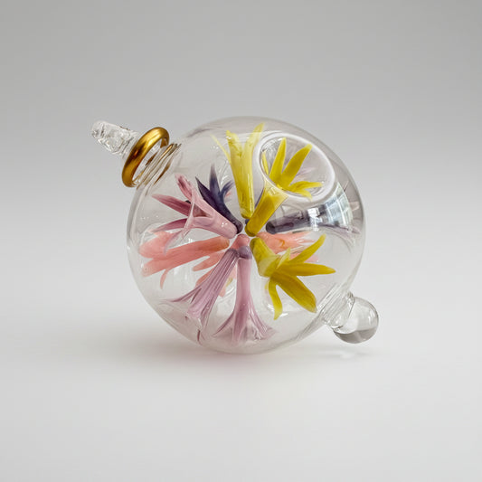Hand-blown glass bauble ornament with floral design on a transparent background, fair trade handcrafted