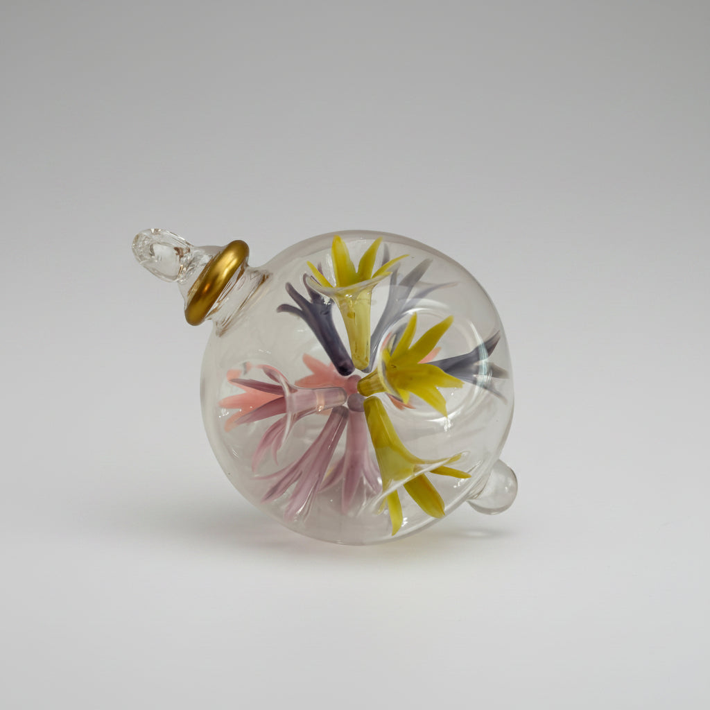Hand-blown glass bauble ornament with floral design on a transparent background, fair trade handcrafted