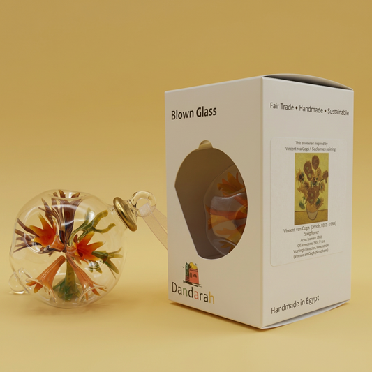 Clear handblown glass ornament with a multicolored floral design inside and gold accents, inspired by Van Gogh's Sunflowers painting