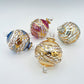 Decorative handblown glass Christmas ornaments with intricate engraved designs and gold hilghlights