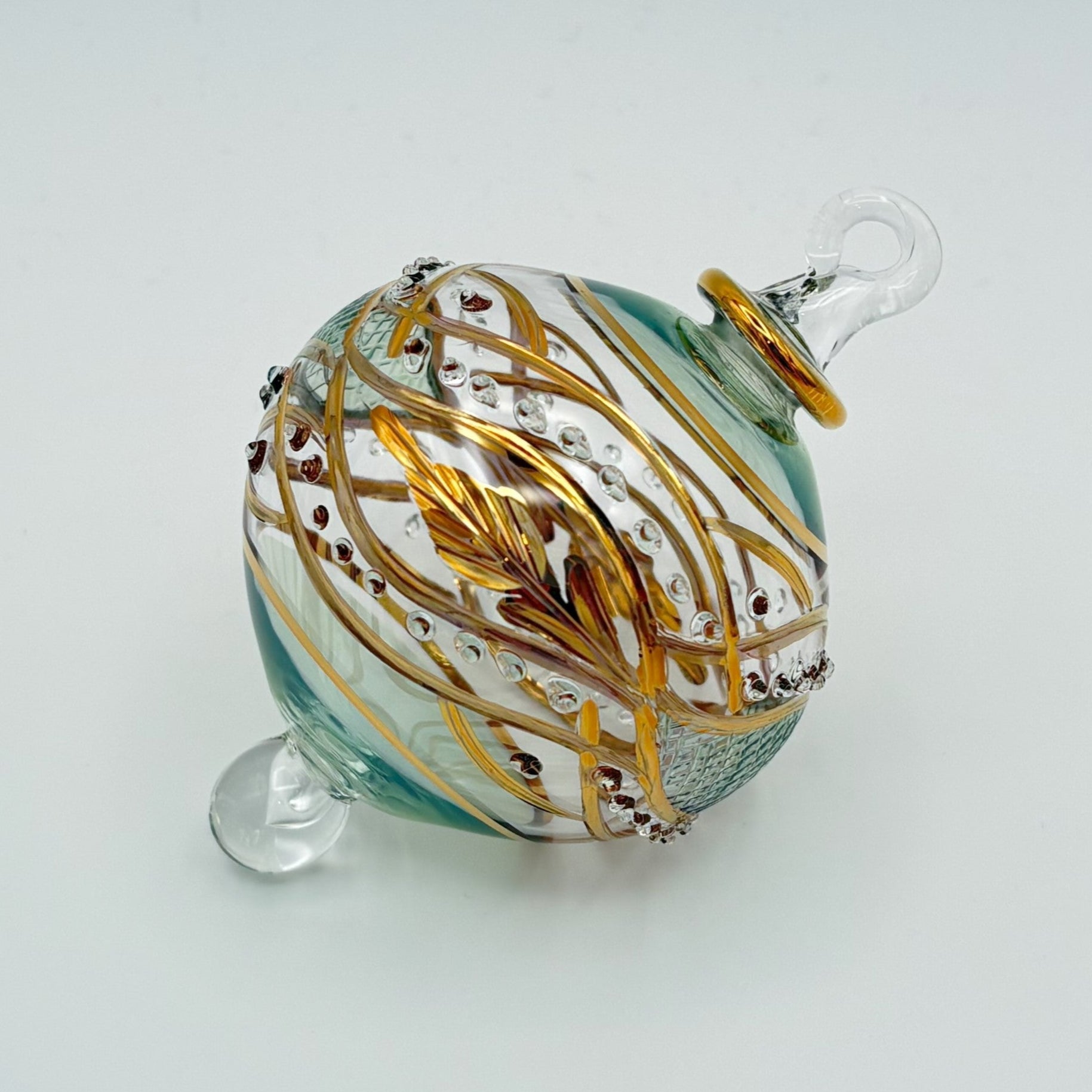 Decorative handblown glass Christmas ornaments with intricate designs and gold hilghlights