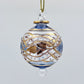 Decorative handblown glass Christmas ornaments with intricate designs and gold hilghlights