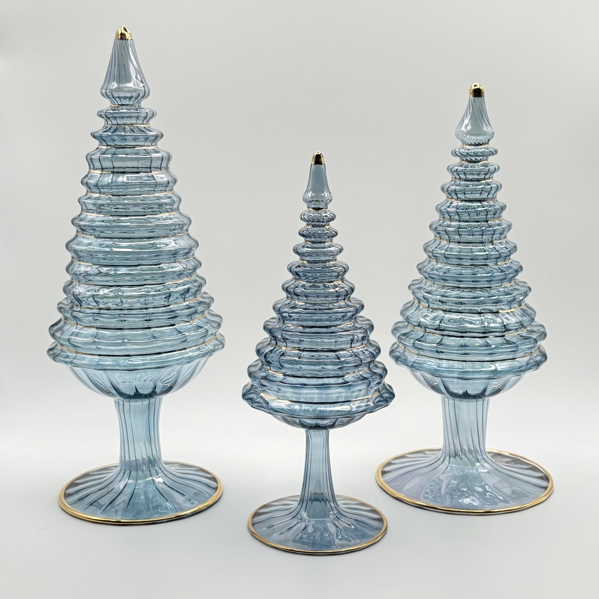 Ethically handcrafted handblown glass Christmas trees in iridescent light blue wiht hand painted gold higlights