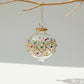 Fair trade handblown glass bauble ornament with gold and colored gem embellishments