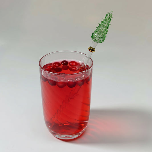 Iridescent hand-blown glass tumbler with a decorative handmade glass green pine tree stirrer with gold detail
