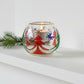 Decorative hand-blown glass candle holder with Christmas trees design and gold detail
