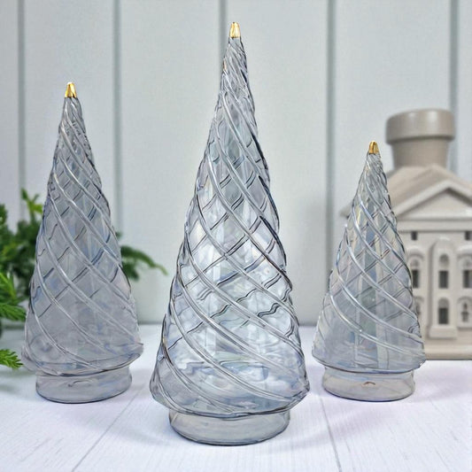 Modern-looking light blue hand-blown glass decorative tabletop Christmas trees with swirl design