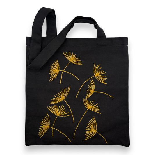 Black tote bag with hand-embroidered mustard papyrus floral patterns
