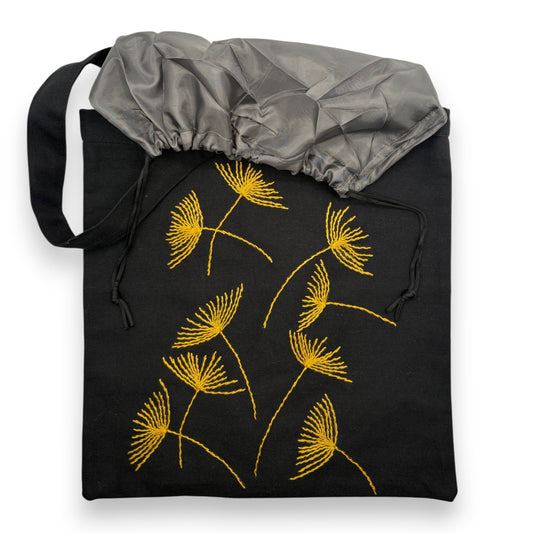 Black tote bag with hand-embroidered mustard papyrus floral patterns