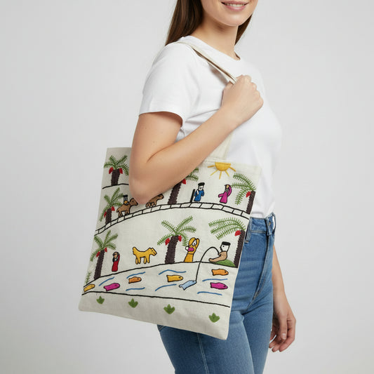 Off-white canvas tote bag with hand-embroidered naive art scene depicting people and animals