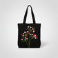 Handmade black tote bag with hand-embroidered red and white floral design, fair trade artisan-made, ethical fashion
