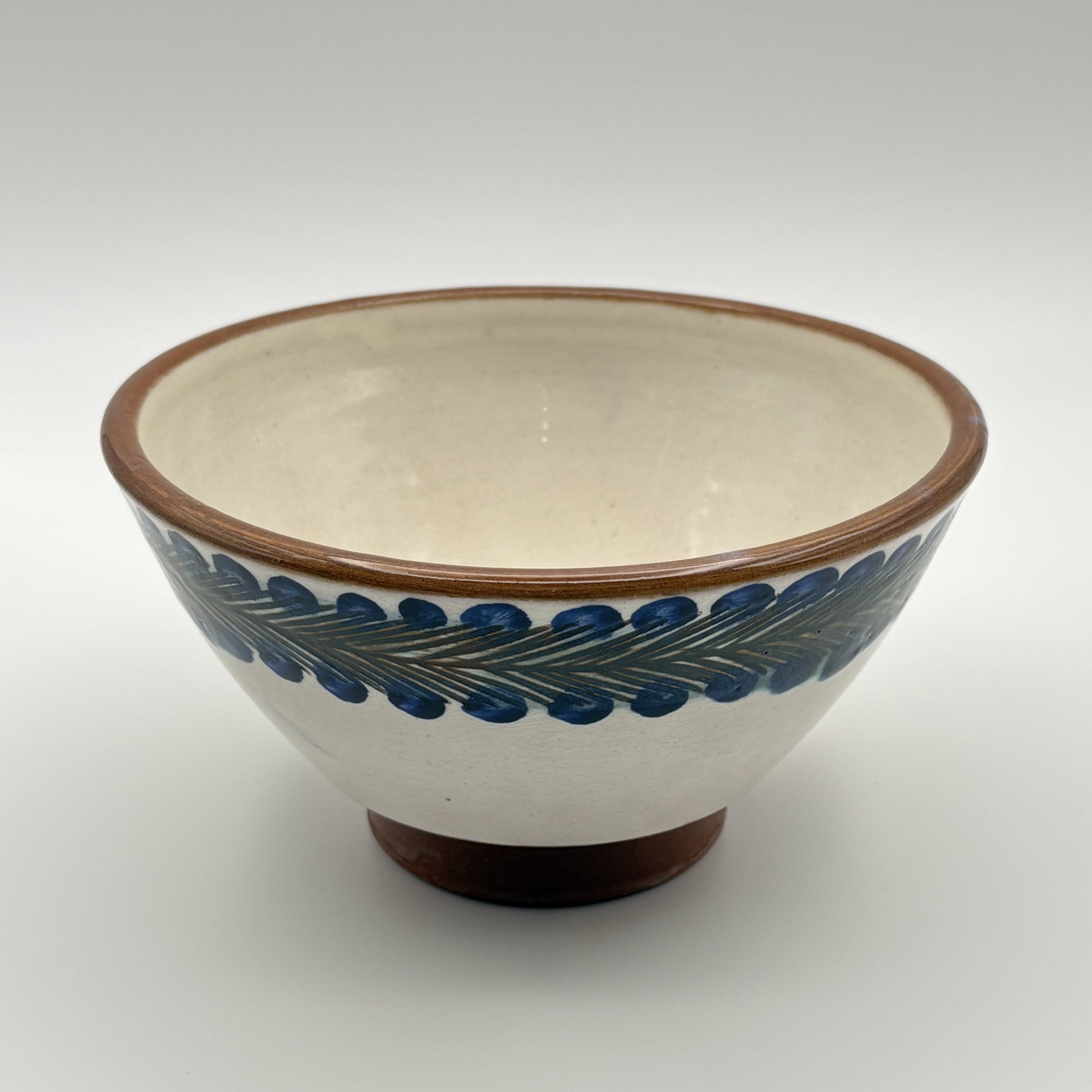 Handcrafted fair trade ceramic bowl with blue and green pattern