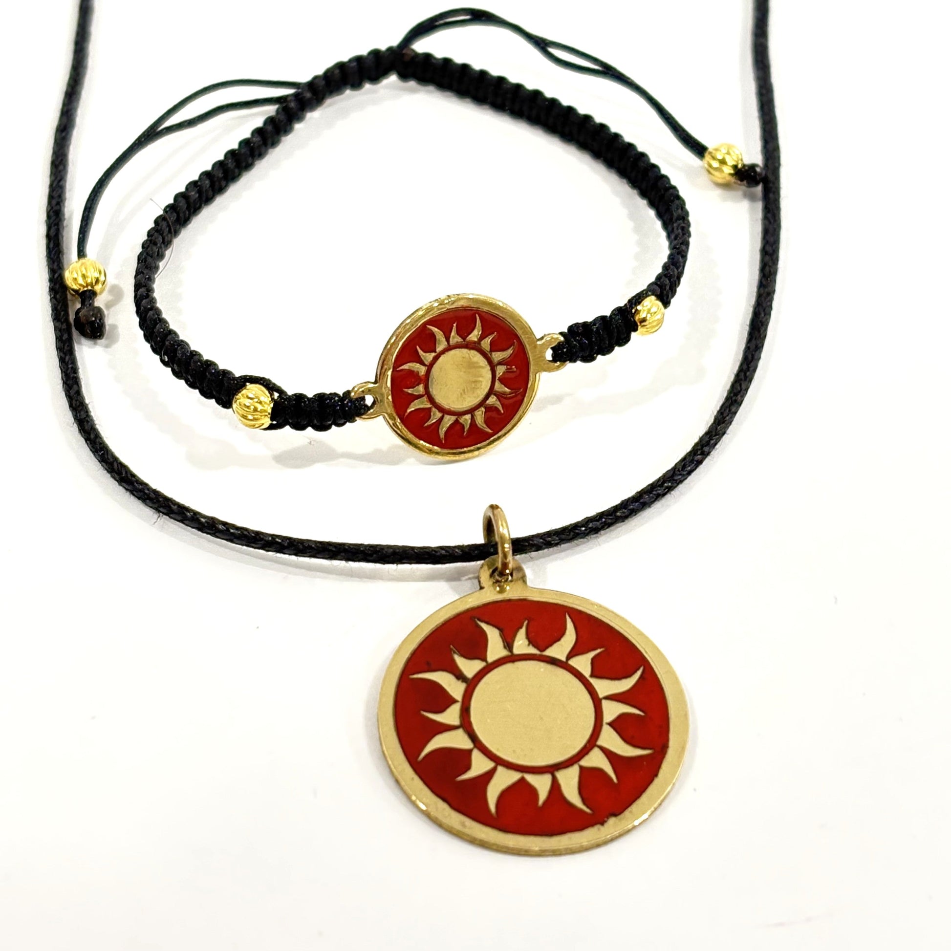 Black macrame bracelet with a brass medallion featuring a gold sun emblem on maroon enamel and matching pendant, fair trade handmade