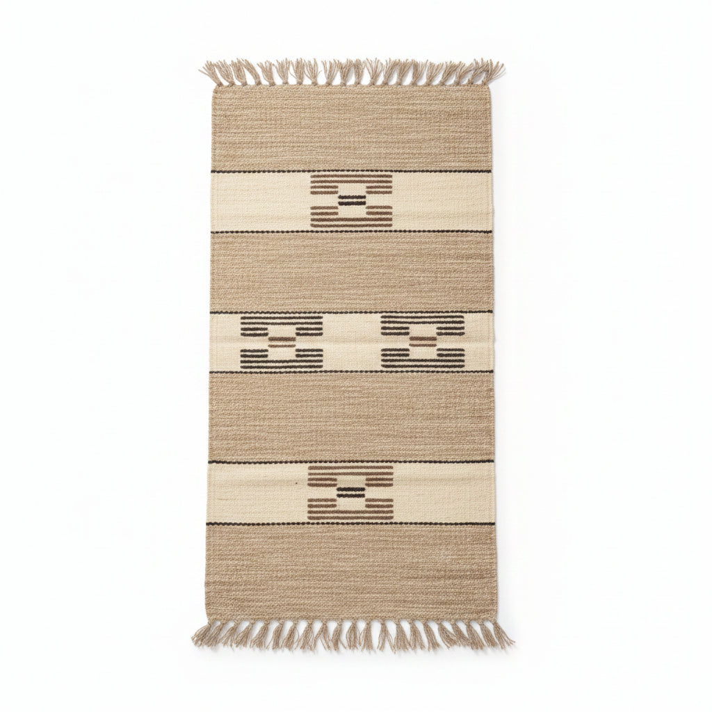 Rectangular handwoven rug with fringes, featuring horizontal stripes and geometric patterns in beige, brown, and cream. Fair trade handcrafted
