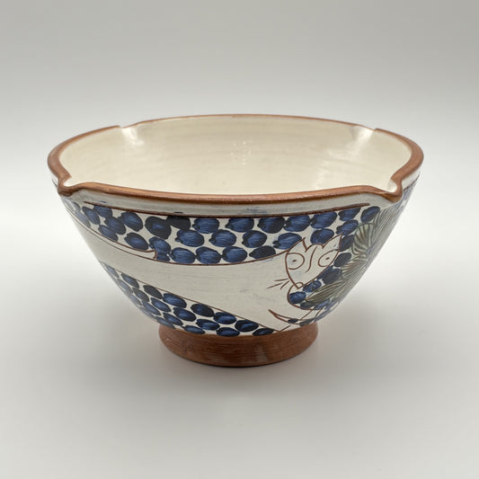 Handmade fair trade ceramic bowl with bouncing cat on a blue and white floral design
