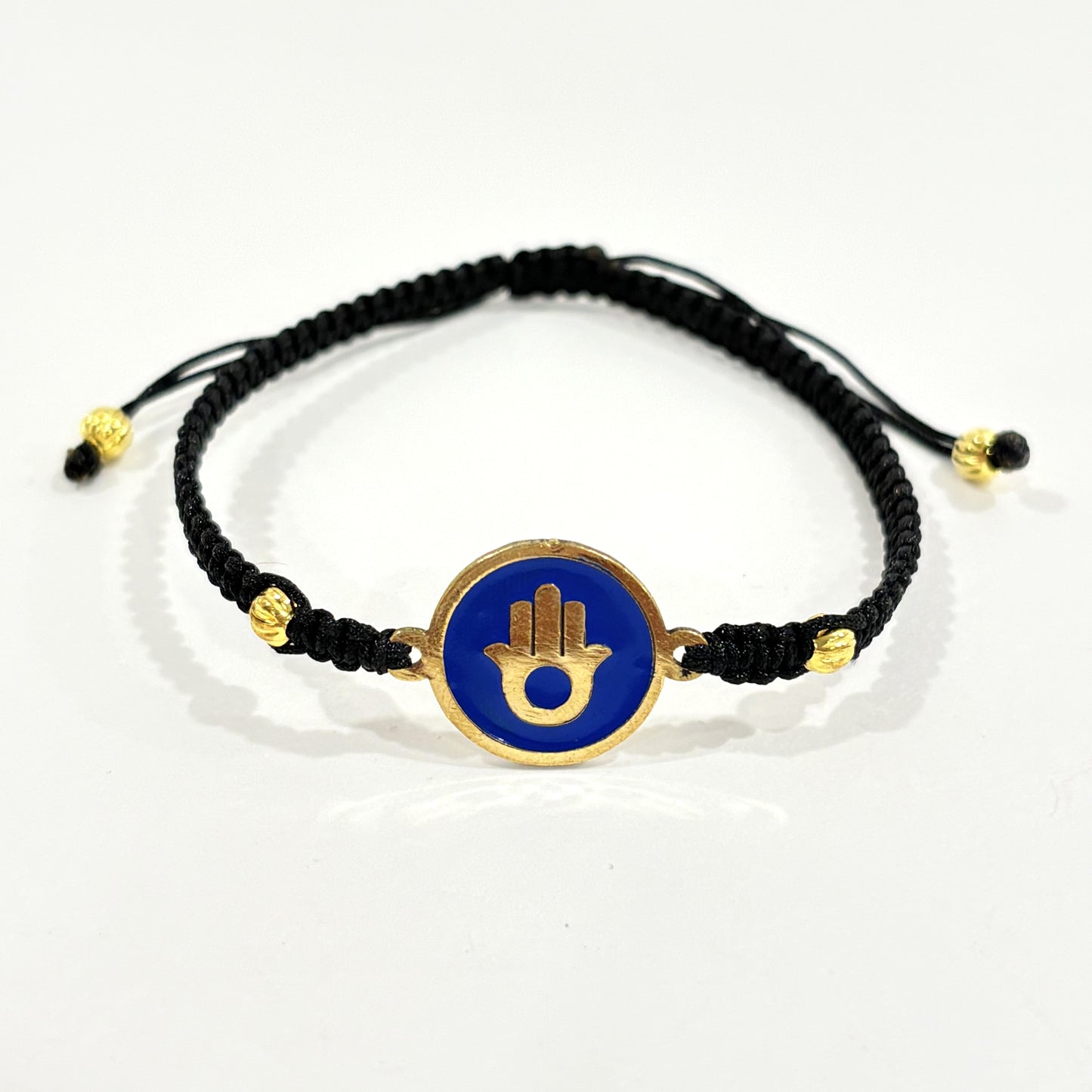 Handmade brass bracelet with a Hamsa symbol on a blue enamel background, fair trade, ethically handcrafted