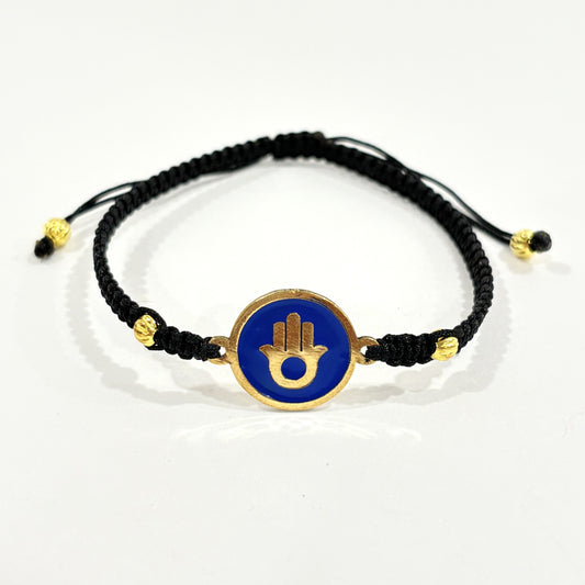 Handmade brass bracelet with a Hamsa symbol on a blue enamel background, fair trade, ethically handcrafted