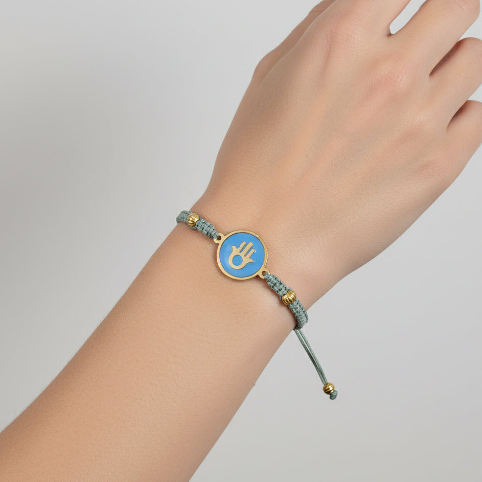 Handmade brass bracelet with a Hamsa symbol on a turquoise enamel background, fair trade, ethically handcrafted
