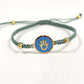 Handmade brass bracelet with a Hamsa symbol on a turquoise enamel background, fair trade, ethically handcrafted