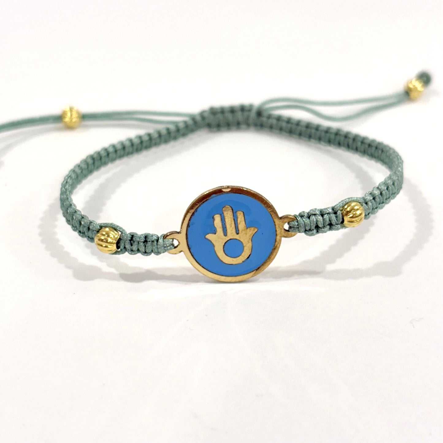 Handmade brass bracelet with a Hamsa symbol on a turquoise enamel background, fair trade, ethically handcrafted
