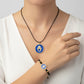 Handmade brass bracelet and pendant with a Hamsa symbol on a blue enamel background on black cord, fair trade, ethically handcrafted
