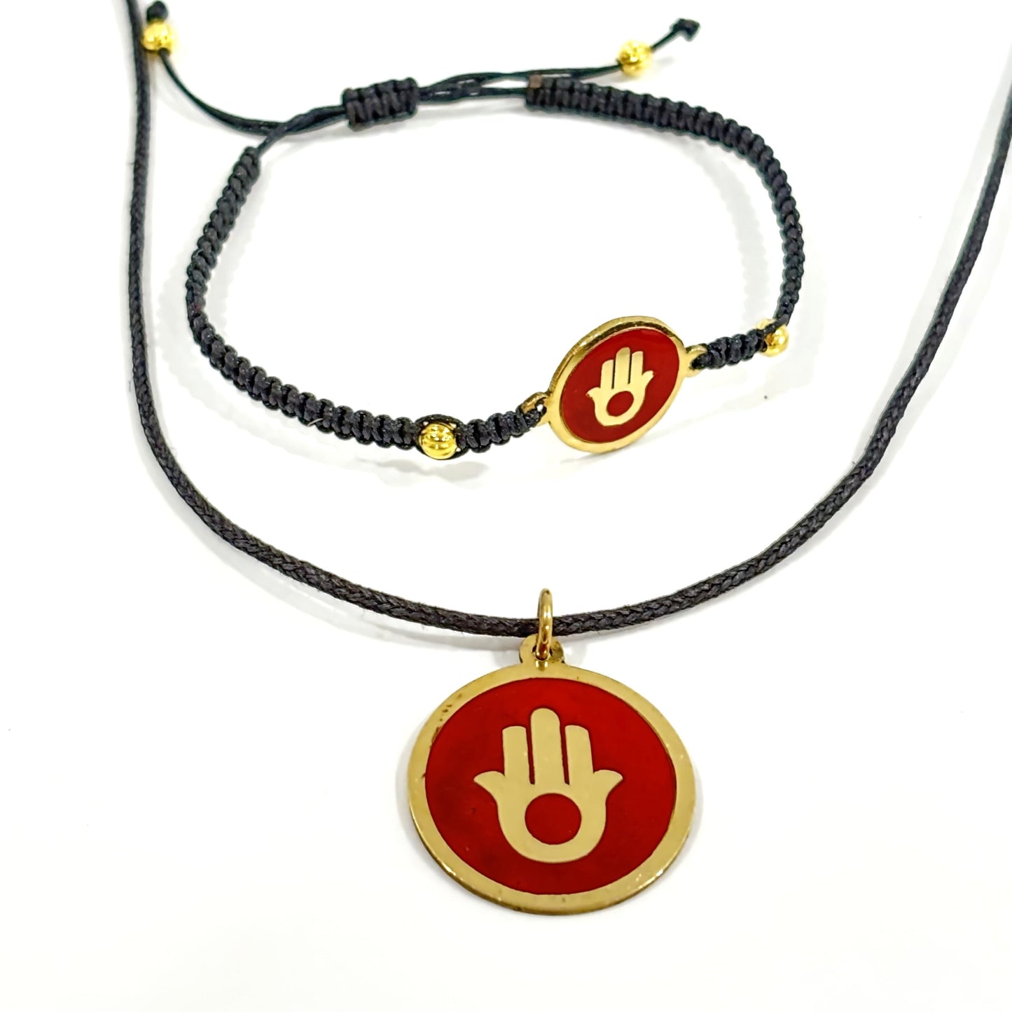 Handmade brass bracelet and pendant with a Hamsa symbol on a maroon red brown enamel background on black cord, fair trade, ethically handcrafted