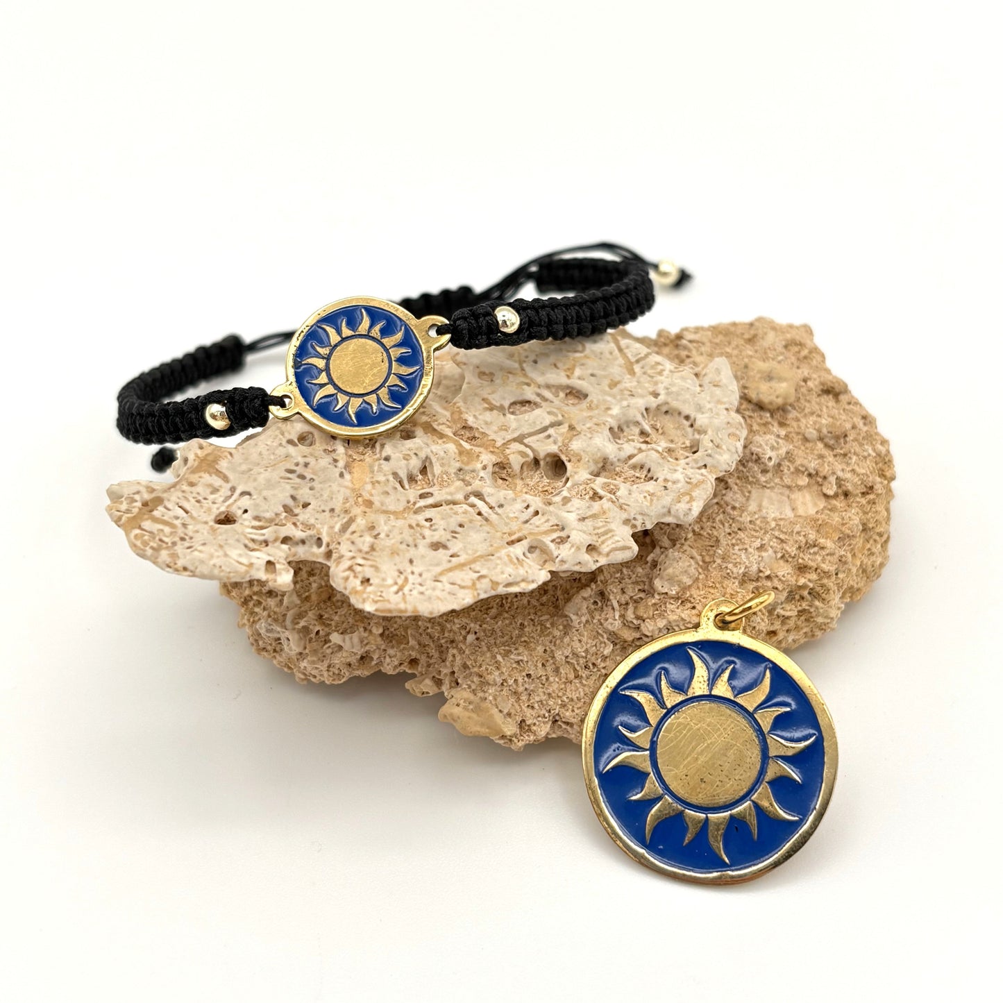Necklace with a handmade brass pendant featuring gold sun against blue enamel and black macrame bracelet with matching medallion, fair trade