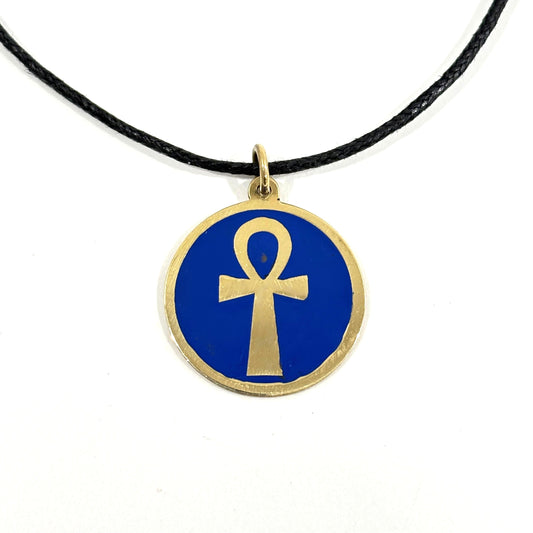 Necklace with a blue pendant featuring a gold ankh symbol, handmade of brass