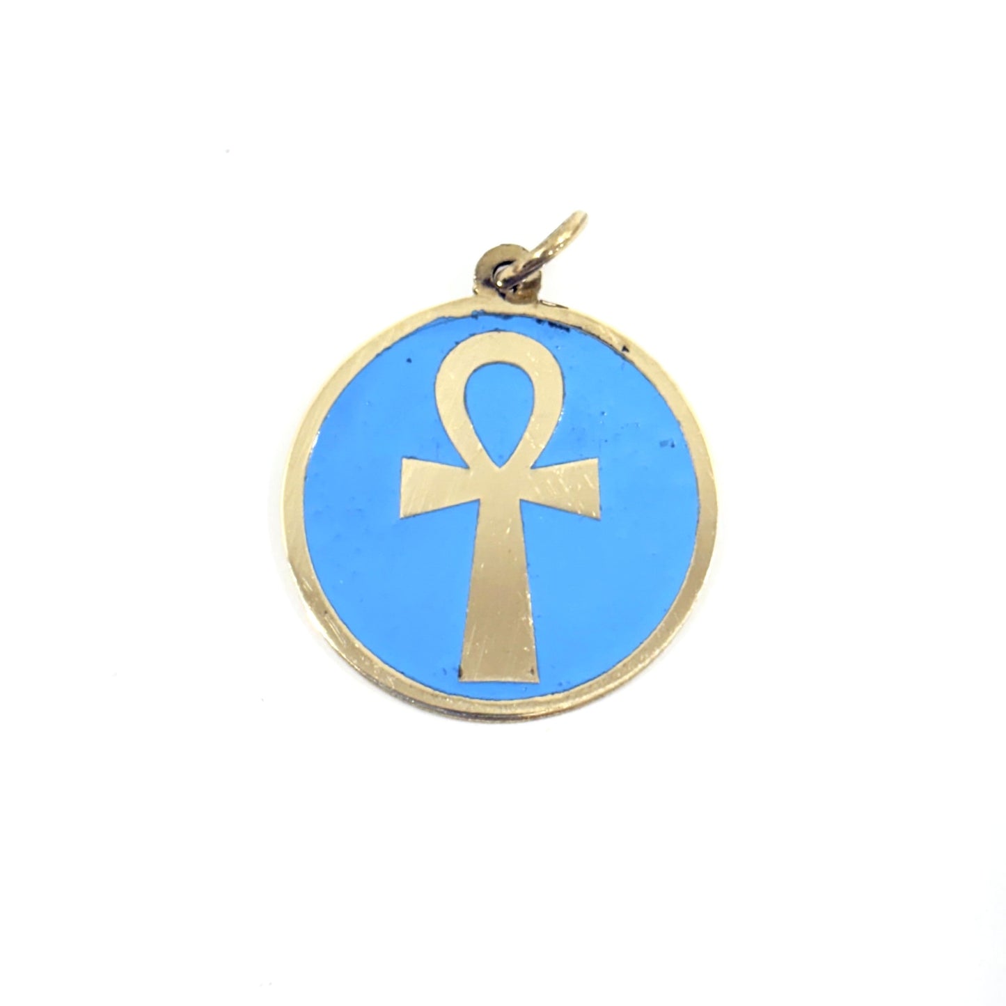 Necklace with a turquoise pendant featuring a gold ankh symbol, handmade of brass