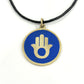 Handmade brass pendant with gold Hamsa hand on blue enamel on a black cord, fair trade, ethically handmade
