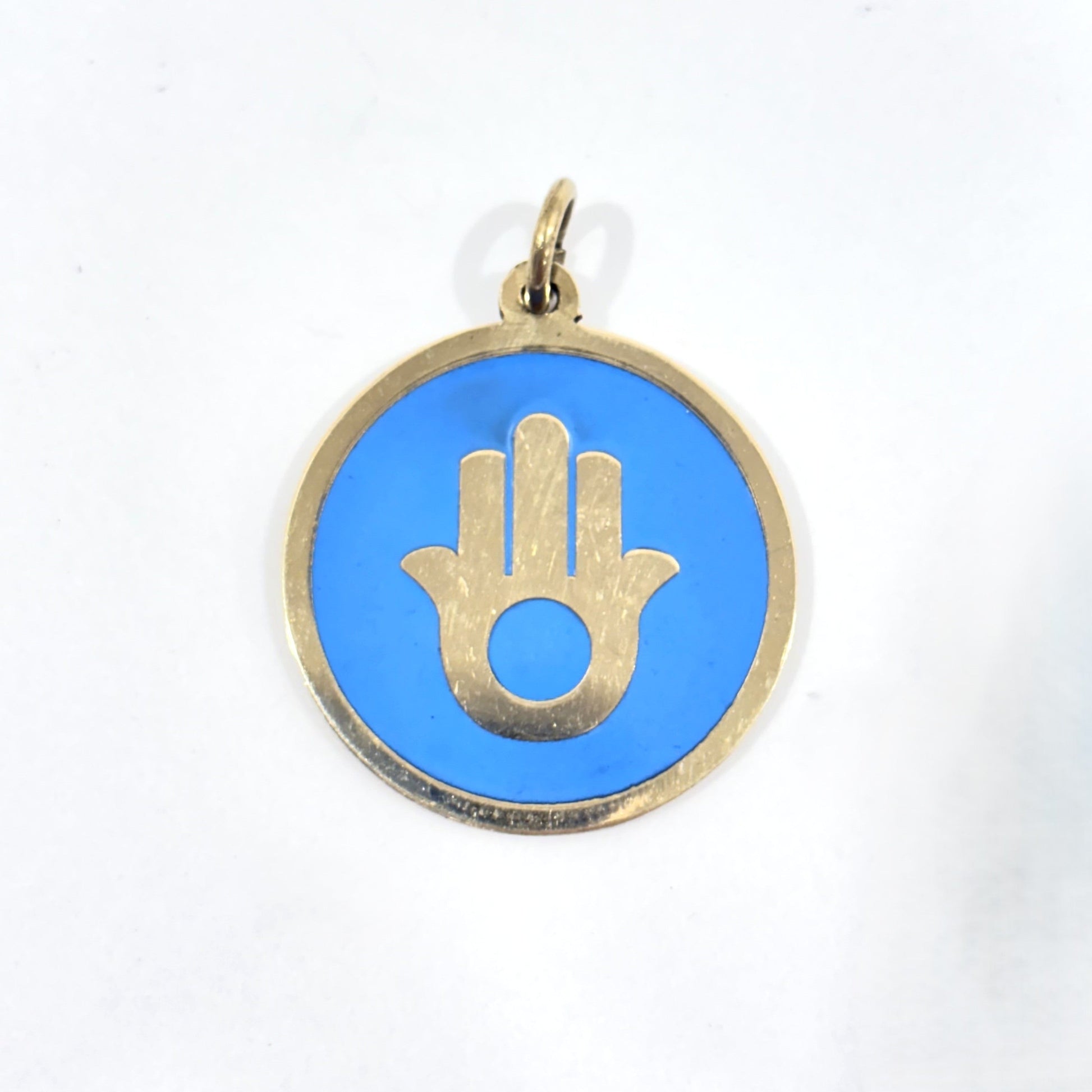 Handmade brass pendant with gold Hamsa hand on turquoise enamel on a black cord, fair trade, ethically handmade