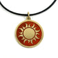 Fair trade handmade brass pendant featuring gold sun against maroon enamel on black cord
