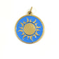 Handmade brass gold sun pendant on a turquoise blue enamel background