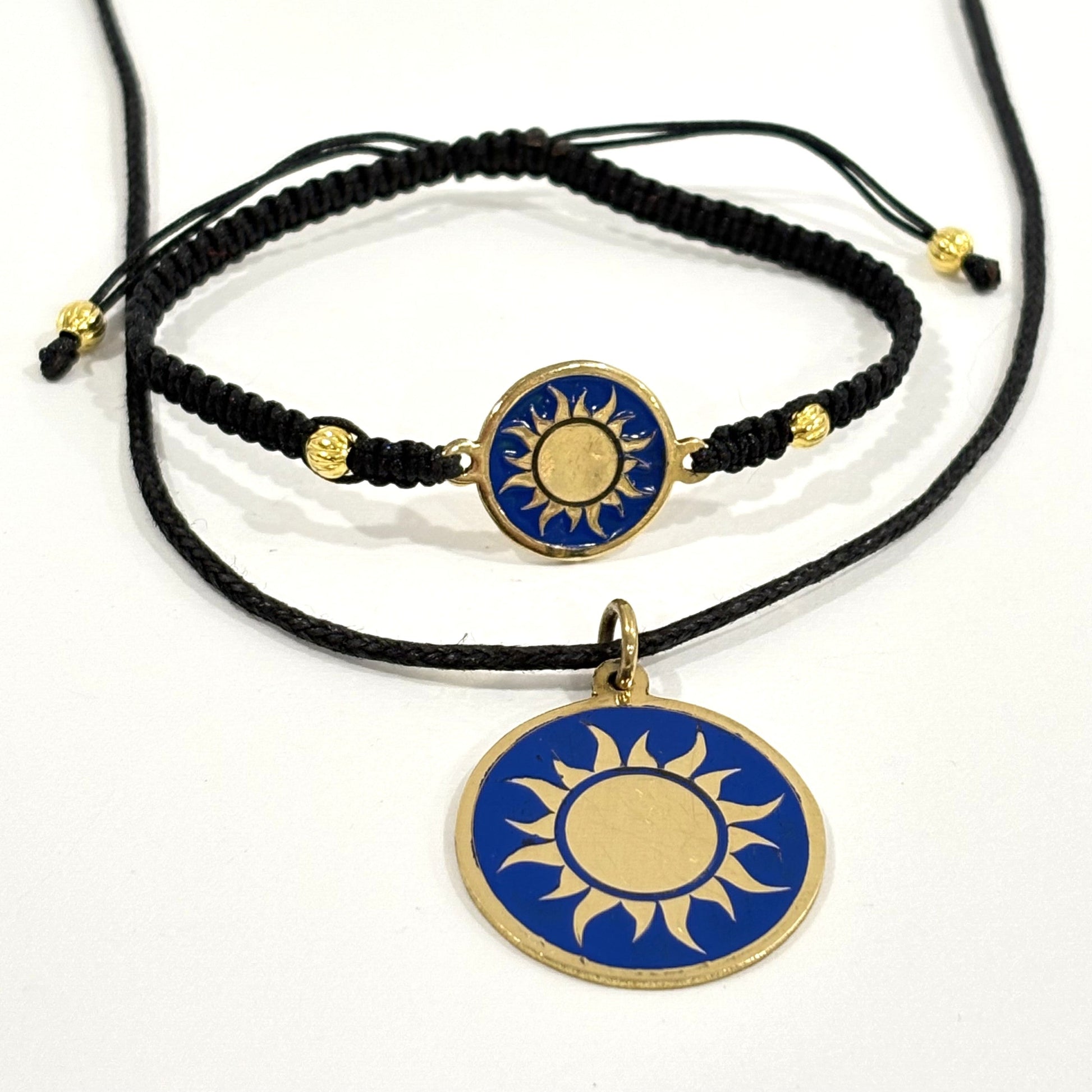 Necklace with a handmade brass pendant featuring gold sun against blue enamel and black macrame bracelet with matching medallion, fair trade