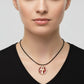 Necklace with a maroon red pendant featuring a gold ankh symbol, handmade of brass