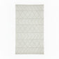 Rectangular handwoven kilim rug in a warm off-white, featuring a textured geometric chevron and diamond pattern