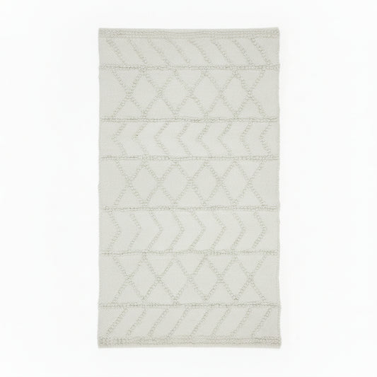Rectangular handwoven kilim rug in a warm off-white, featuring a textured geometric chevron and diamond pattern