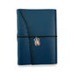 Handbound dark blue leather journal with a diagonal fold closure, secured by an elastic band featuring a silver scarab charm