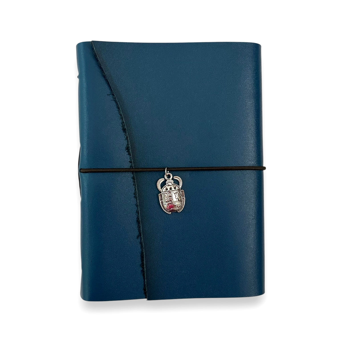 Handbound dark blue leather journal with a diagonal fold closure, secured by an elastic band featuring a silver scarab charm