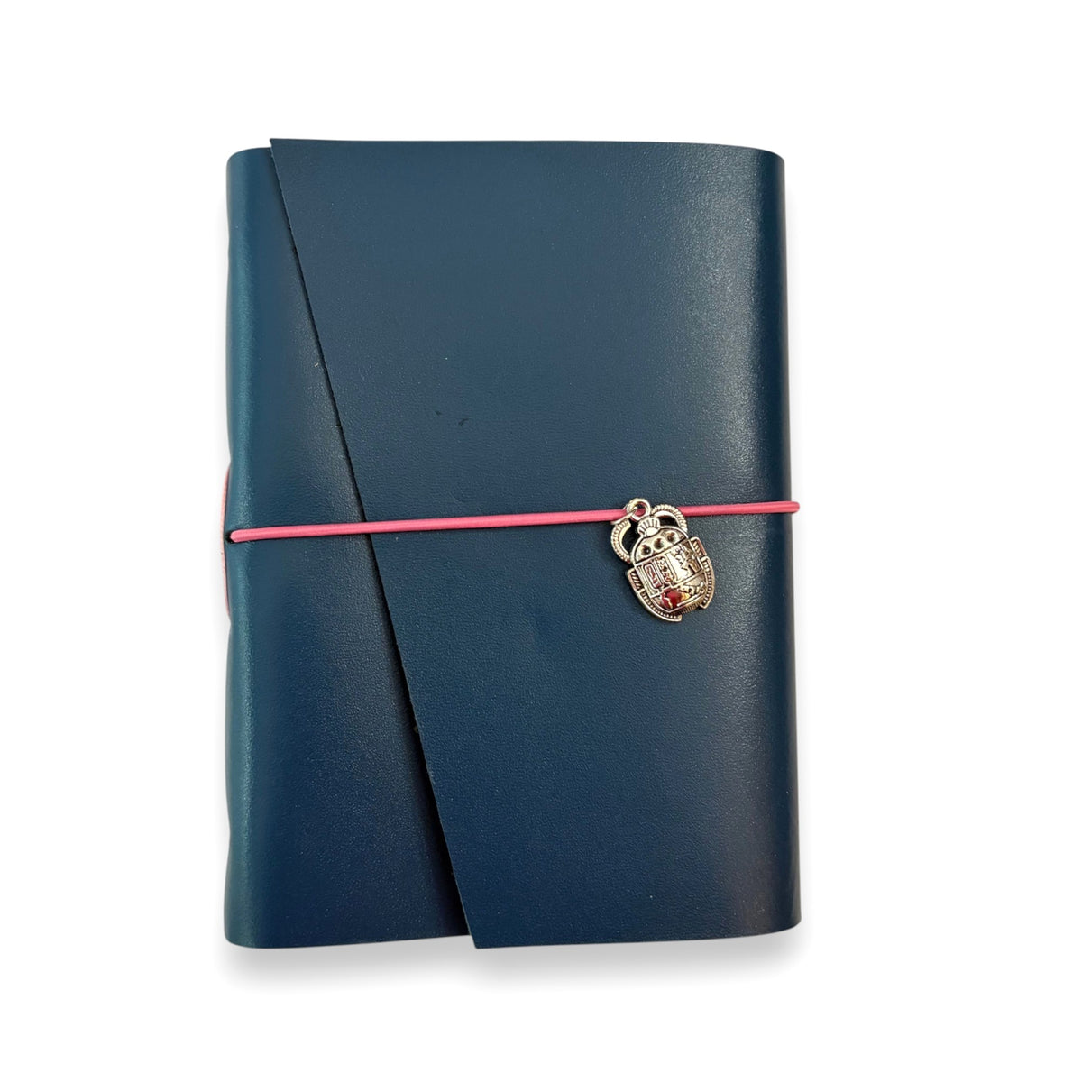 Handbound dark blue leather journal with a diagonal fold closure, secured by an elastic band featuring a silver scarab charm