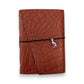 Rust red handbound leather journal with a wrap-around elastic strap and a silver metal cat goddess Bastet Charm