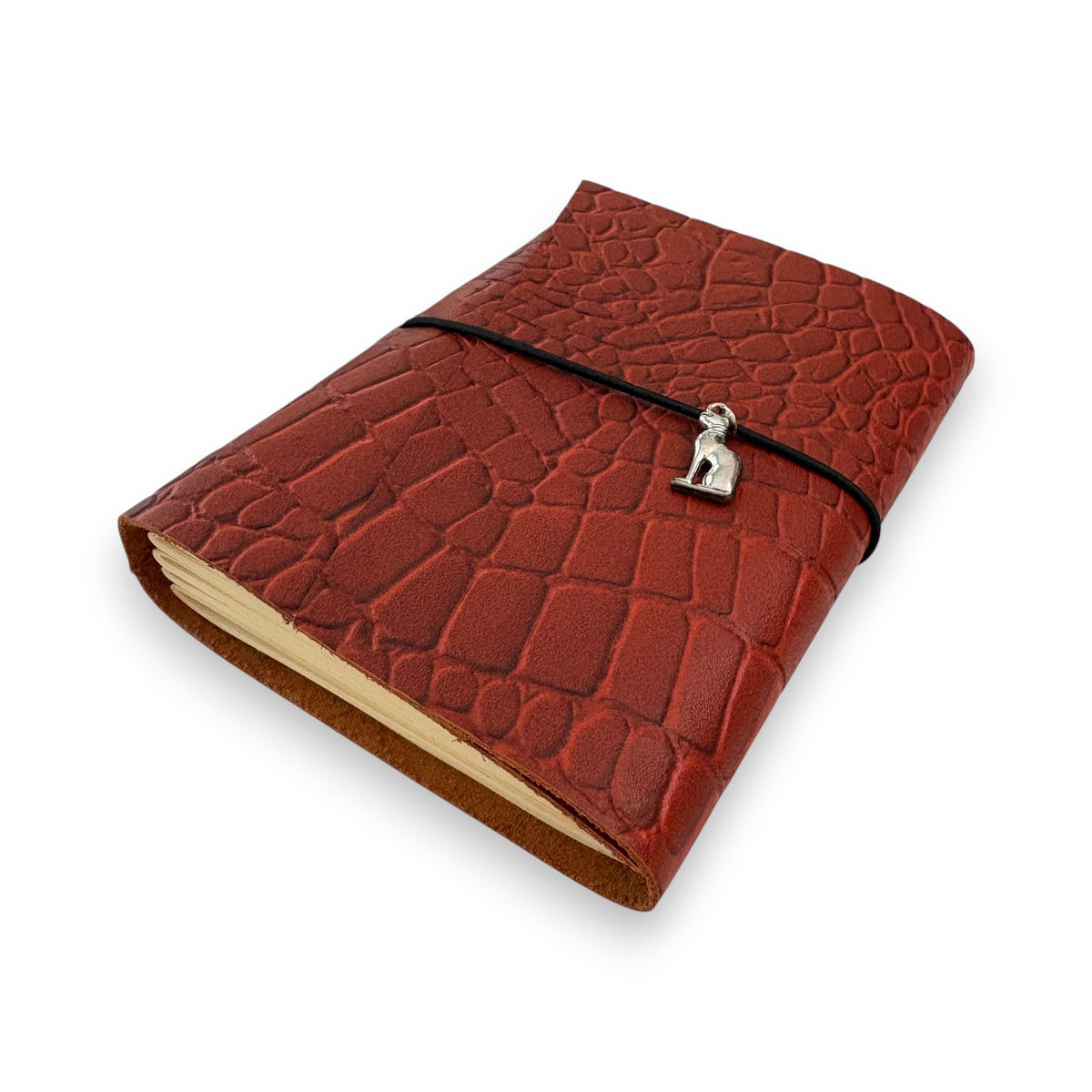 Rust red handbound leather journal with a wrap-around elastic strap and a silver metal cat goddess Bastet Charm