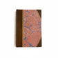Hand-bound hardcover notebook with brown leather binding and corners, featuring a marbled Ebru paper and thin gold decorative lines, Fair trade handcrafted