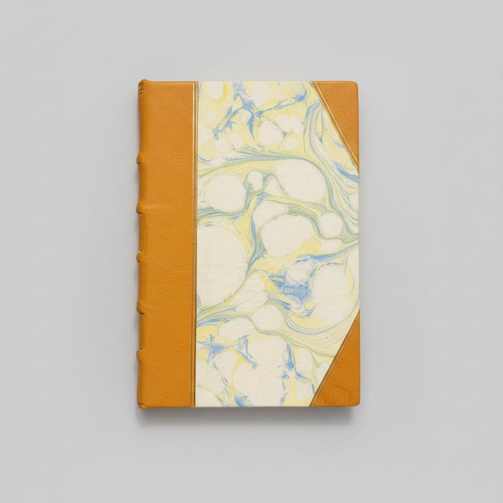 Handmade notebook with marbled design and mustard binding