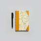 Handmade notebook journal with marbled cover and mustard leather binding