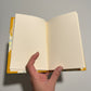 Handmade notebook journal with marbled paper cover and mustard leather corners 
