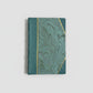 Hand-bound hardcover notebook with teal blue leather binding and corners, featuring a marbled Ebru paper and thin gold decorative lines, Fair trade handcrafted