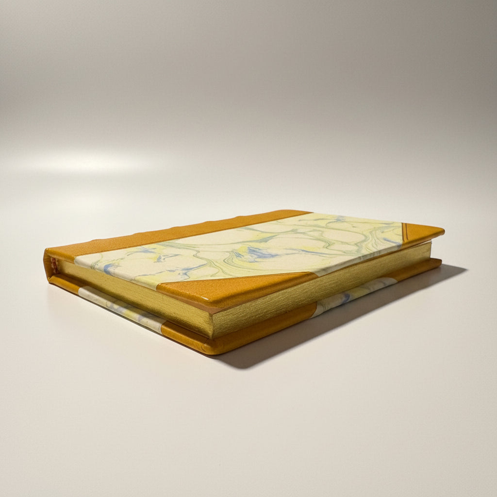 Handmade notebook journal with marbled paper cover and mustard leather corners 